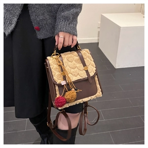 Detail of vintage mini backpack showing brown leather and beige faux fur texture