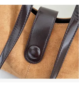 Macro detail of the brown suede fabric and smooth dark leather straps with neat stitching