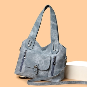 Vintage light blue soft leather tote bag with functional pockets and adjustable shoulder strap