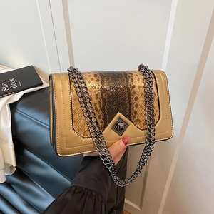 Gold chain shoulder bag with brown snake pattern panel and metallic twist lock