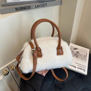 Chic white faux fur handbag with brown leather handles and adjustable shoulder strap