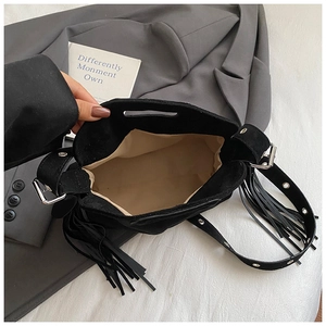 Top view of spacious black suede fringe bag interior showing light beige lining