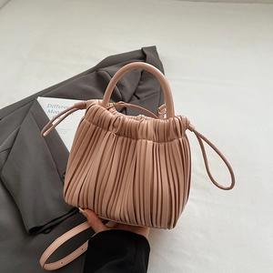 French pleated shoulder bag in soft dusty pink leather with drawstring closure