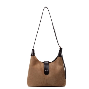 Retro brown suede crescent shoulder bag with dark leather strap and buckle detail