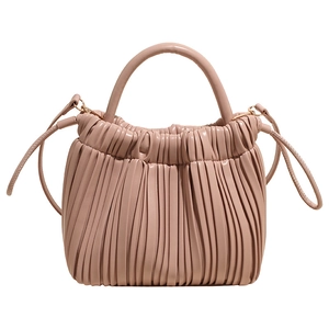Chic ruched dumpling bag in pale pink soft leather with top handle and crossbody strap