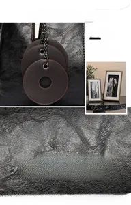 Close-up of black wrinkled leather texture with brown charms and black metal chain detail