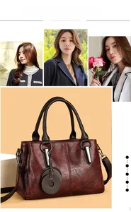 Detail of burgundy PU leather tote bag with lychee texture and round brown handles