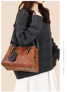 Detailed view of the dark brown retro texture tote bag with metallic zipper and shoulder strap