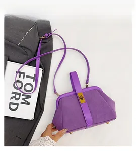 Macro detail of purple matte shell bag featuring metal clasp lock and textured finish