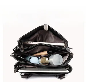 Interior view showing large capacity compartments with books and tablet in a black tote bag