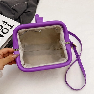 Macro view of purple shell bag interior with beige herringbone lining and zipper pocket