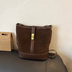 Retro dark brown suede bucket bag with leather trim and gold twist-lock buckle