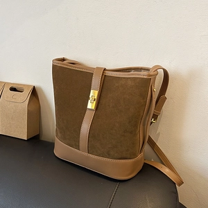 Vintage brown suede bucket bag with adjustable shoulder strap and gold twist lock