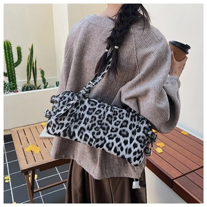 Detail of grey leopard print bag featuring soft texture and silver metallic buckle strap