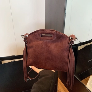 Vintage dark brown suede shoulder bag with tassels and unique cutout handles