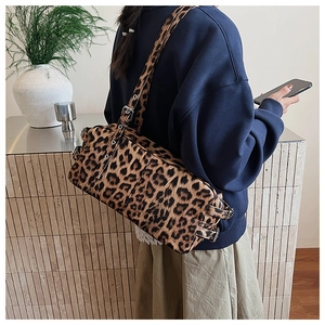 Detailed macro view of the soft faux fur leopard print texture and silver metal buckle