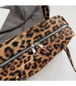 Close-up of smooth silver dual-way metal zippers on leopard print bowling bag detail