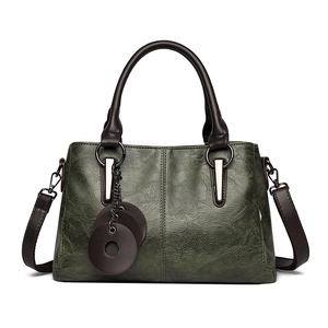 Vintage dark green oil-wax leather tote bag with dark brown handles and round tags