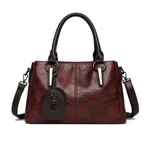 Retro burgundy tote bag with contrast stitching and glossy faux leather finish