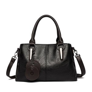 Vintage black textured tote bag with top handles and silver metal hardware details