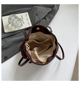Interior view of brown corduroy tote bag showing satin lining and zip pocket