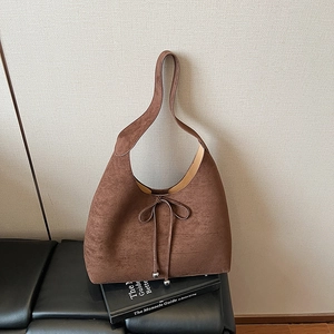 Brown suede tote bag with decorative bow and silver beads for stylish women