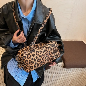 Retro leopard print cylinder shoulder bag with adjustable eyelet strap on model