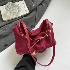 Vintage burgundy suede handbag with gold metal ring and elegant drawstring design