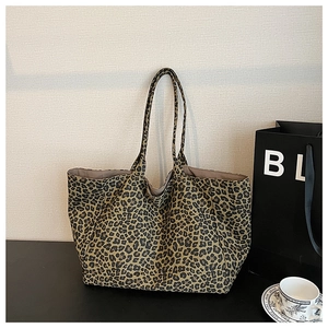 Detail shot of the large leopard print tote bag with long shoulder straps and canvas texture
