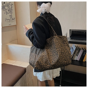 Detailed view of the leopard print canvas tote bag styled in a modern home office setting
