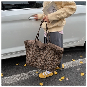 Outdoor street view of the leopard print canvas tote bag showing large capacity