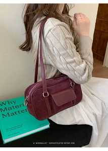 Detail of burgundy faux suede baguette bag showing the fine texture and silver zipper
