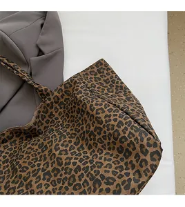Detail of soft leopard print canvas fabric on a spacious tote bag with luxury texture