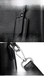 Détail du cuir grainé noir avec crochet en métal argenté et breloque décorative ronde