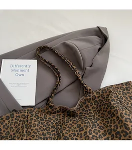 Flat lay of vintage leopard print canvas tote bag with long shoulder straps and spacious interior