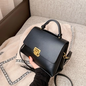 Classic black vintage crossbody handbag with gold hardware and a top handle for women