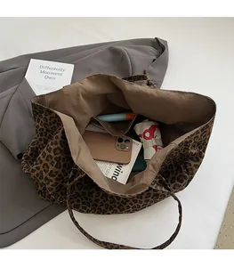 Detailed interior view of leopard print canvas tote bag showing large capacity and pockets