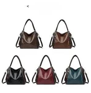 Five assorted hobo bags in glossy vegan leather featuring multiple color variations