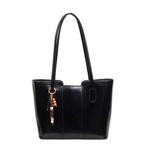 Retro black leather tote bag with vertical stitching and colorful wooden bead charm detail