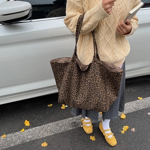 Stylish large leopard print canvas tote bag shown in an autumn street fashion setting