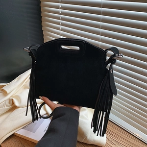 Retro black suede fringe shoulder bag with bohemian tassels and cutout handle design