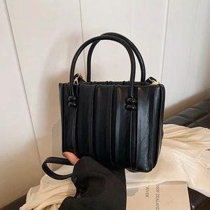 Chic black vertical pleated handbag for women with double handles and shoulder strap
