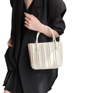 Minimalist pleated faux leather handbag in white with circular handle details for women