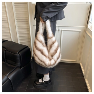 Detail of plush faux fur handbag featuring trendy brown and white diagonal stripes