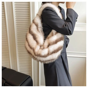 Detail view of the soft brown and white striped faux fur texture on the shoulder bag