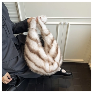 Detail of soft striped faux fur tote bag with plush handle shown in a lifestyle setting