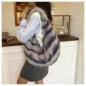 Macro detail of striped faux fur hobo bag showing thick texture and grey-black pattern