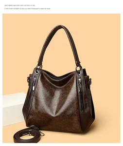Detailed shot of brown vintage tote bag featuring crackle texture and dual zipper detail