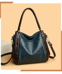 Detail of vintage tote bag showing woven handles and side metal zipper decoration