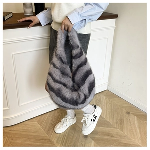 Detail of soft gray striped faux fur tote bag with plush texture and water-drop shape